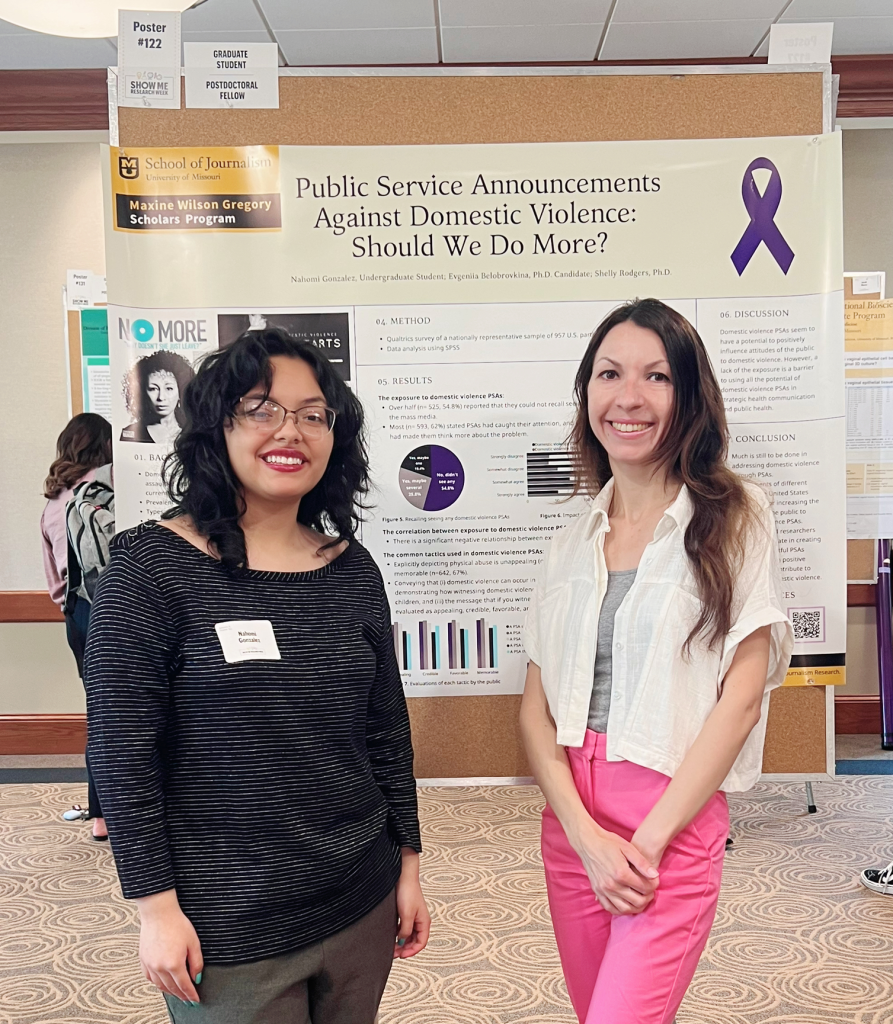 Photo of Nahomi Gonzalez and Evgeniia Belobrovkina with their research poster at the 2023 Spring Research Forum.